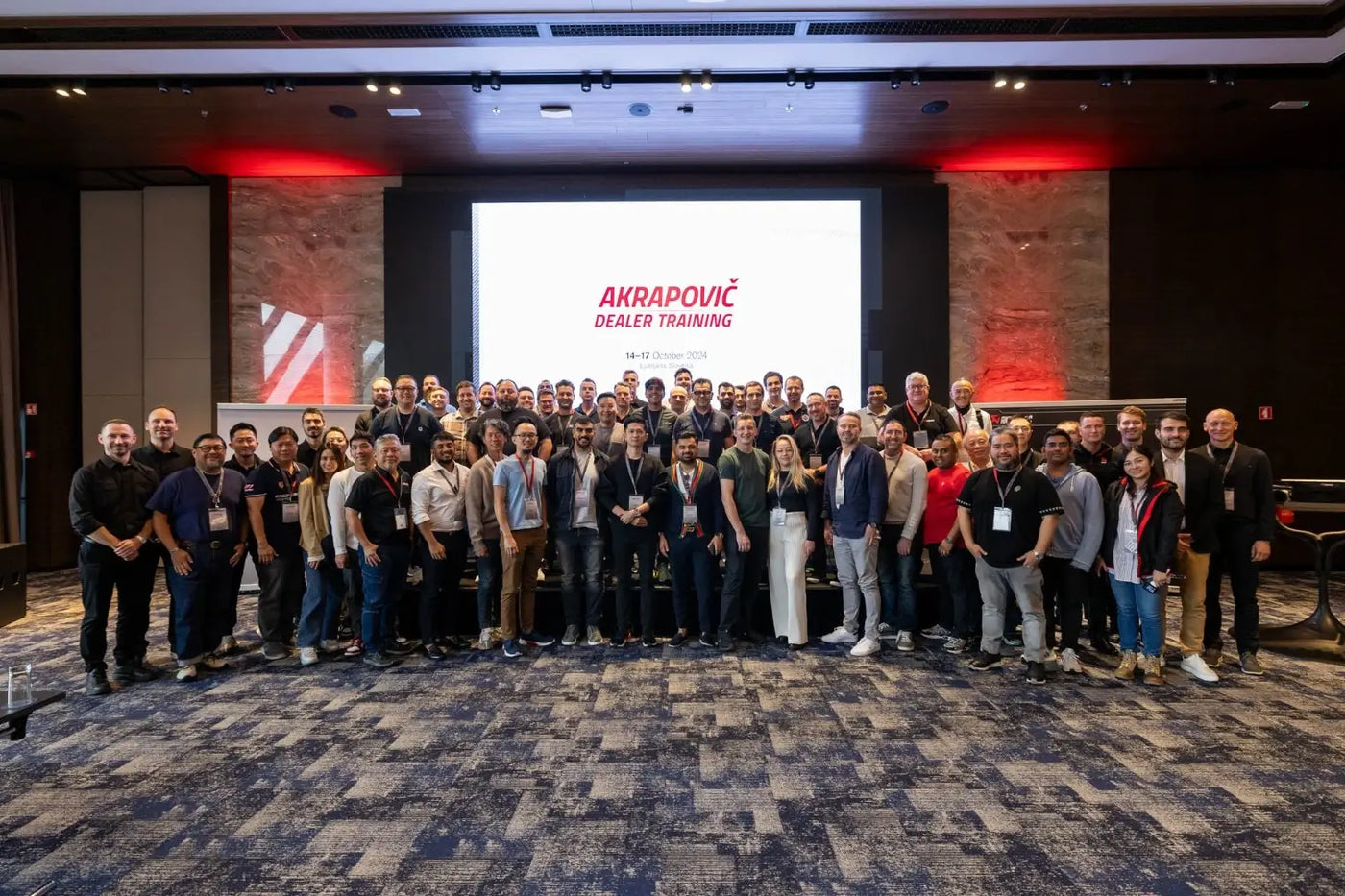 Group shot of dealers and Akrapovič leaders during the 2024 Akrapovič Dealer Training event, highlighting collaboration and innovation in performance exhausts.