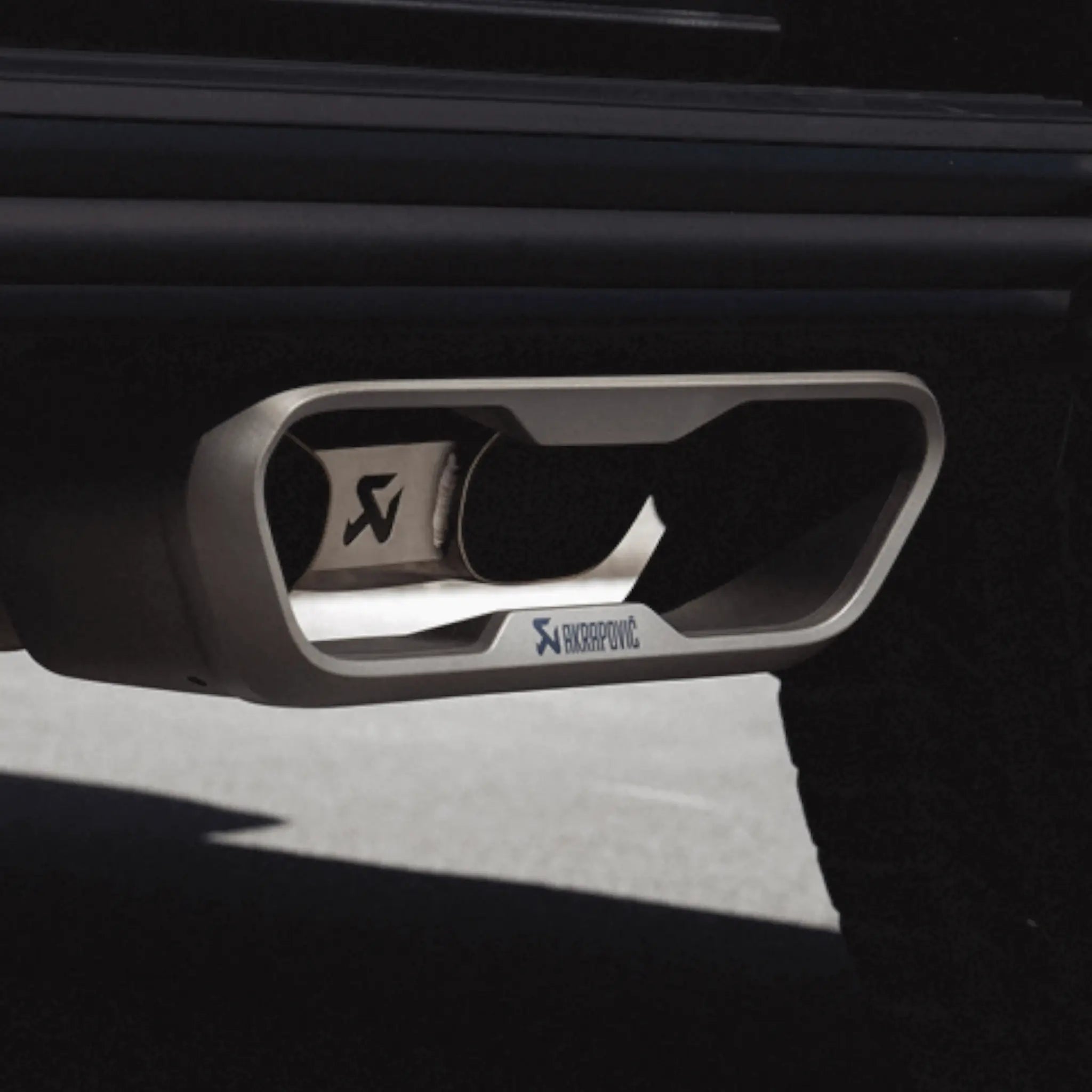 Detailed close-up of Akrapovic dual-exit titanium tailpipes from the Evolution Line Titanium Performance Exhaust installed on Mercedes-AMG G 63, showcasing premium finish and precise fitment.