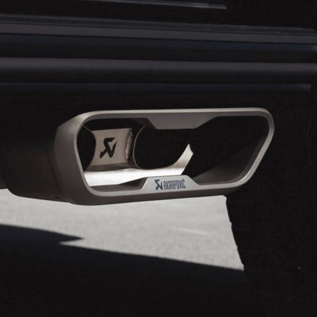 Detailed close-up of Akrapovic dual-exit titanium tailpipes from the Evolution Line Titanium Performance Exhaust installed on Mercedes-AMG G 63, showcasing premium finish and precise fitment.