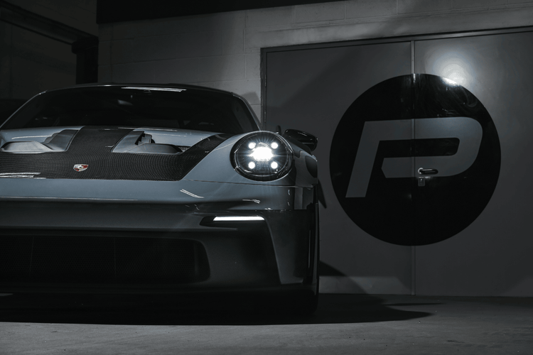 A rear angle view of the 992.1 Porsche Turbo S in the Performance Workshop with the Akrapovic performance exhaust system installed, showcasing its seamless integration and craftsmanship.