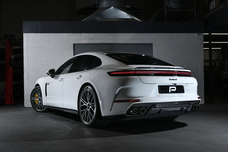 A rear angle view of the 992.1 Porsche Turbo S in the Performance Workshop with the Akrapovic performance exhaust system installed, showcasing its seamless integration and craftsmanship.