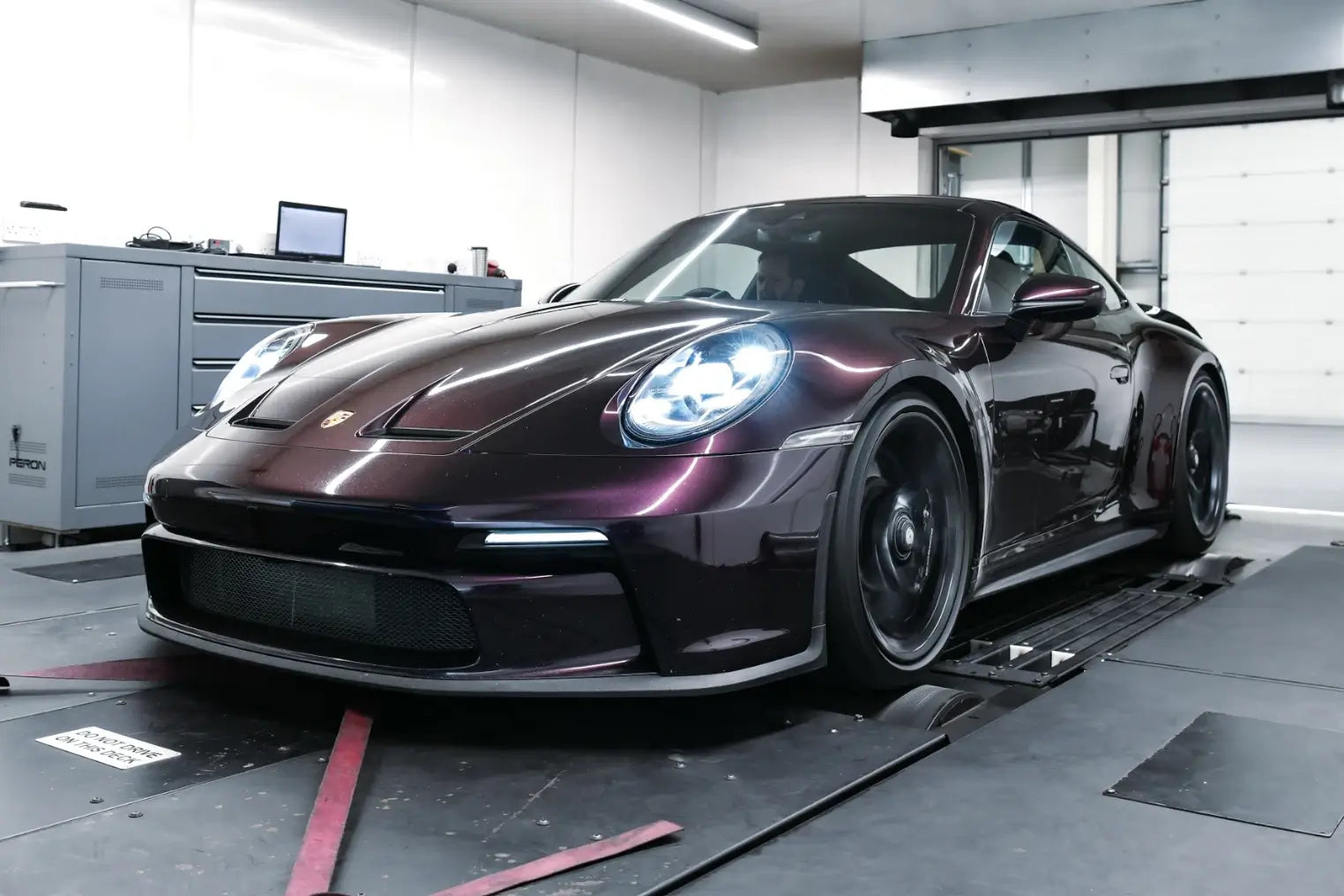 Front angle shot of 992.1 GT3 on PERON’s in-house dyno during ECU tuning, highlighting performance workshop environment and precision tuning.