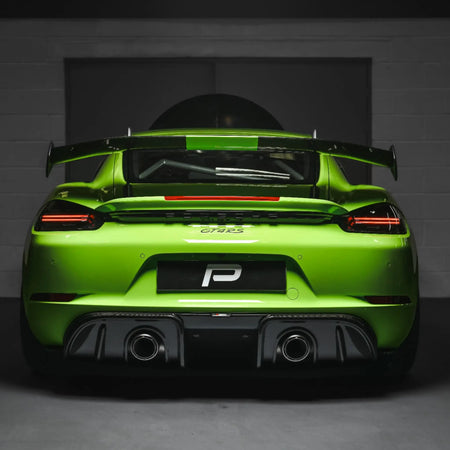 Porsche 718 Cayman GT4 RS with Akrapovic Slip-On Race Line and carbon diffuser installed, photographed in PERON’s Performance Workshop.