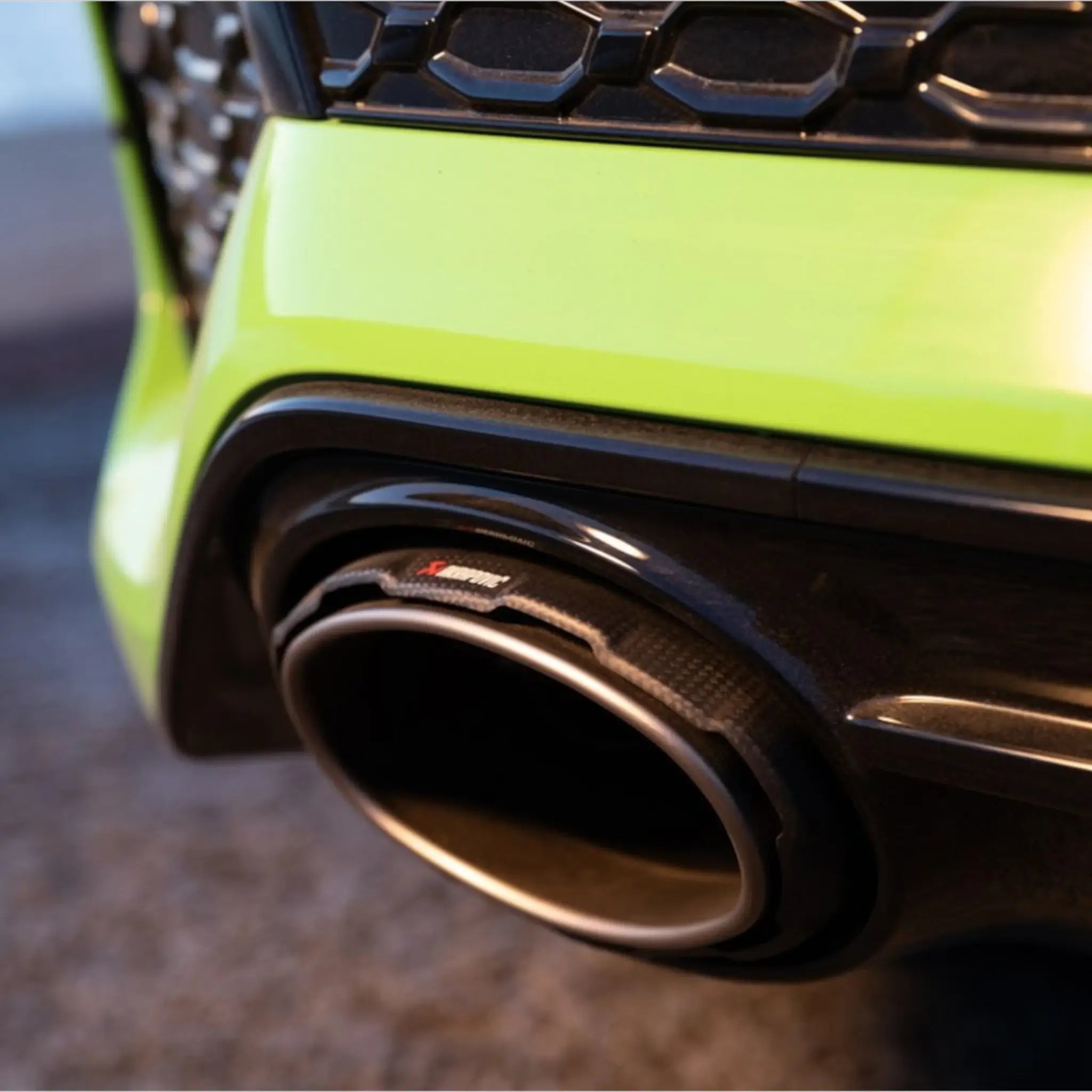 Detailed close-up of the carbon-fibre tailpipe installed on the Audi RS 3 8Y, showcasing Akrapovič’s premium craftsmanship and engineering excellence.