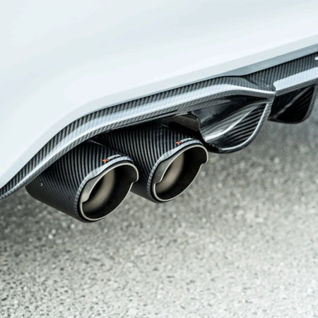 Detail shot showcasing the precision-crafted Akrapovic carbon tailpipes and the optional carbon fibre diffuser, designed for the F87N BMW M2.