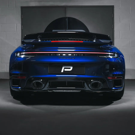 Rear shot of a Porsche 911 Turbo S 992.1 in PERON Performance Workshop, fitted with the Akrapovič Slip-On Race Line (Titanium) performance exhaust.